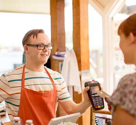 Man taking payment in a shop