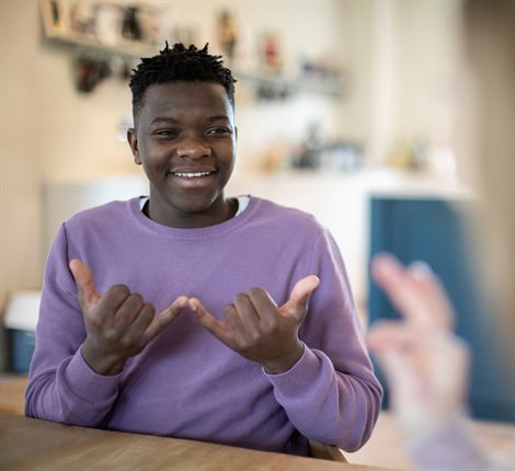 Two people have a conversation using sign language
