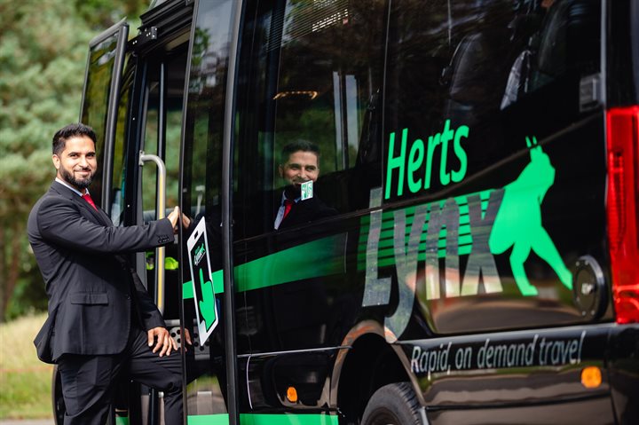 Driver boarding a HertsLynx minibus