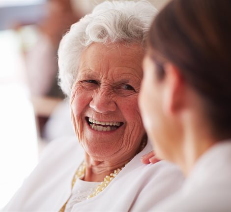 Older lady laughing with younger woman