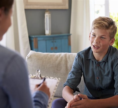 Teenage boy talking to a counsellor